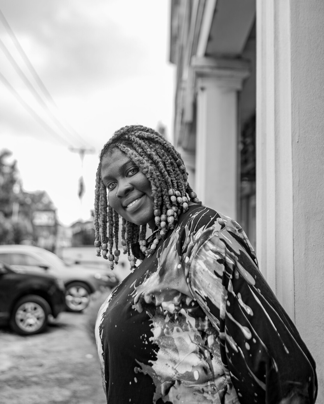Studio portrait of a smiling Brazilian woman with braids