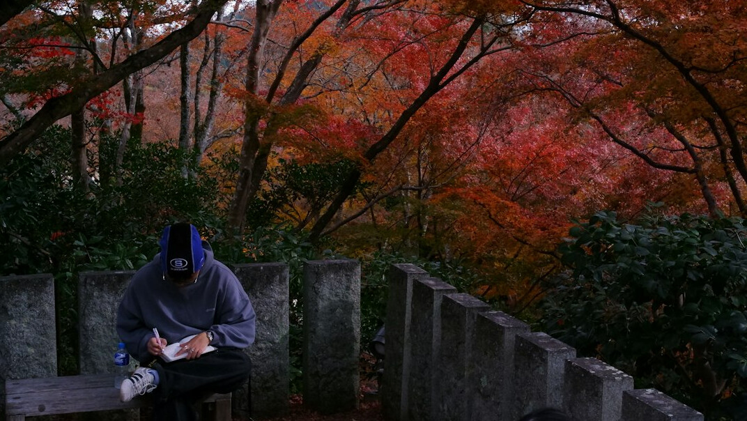 person writing in notebook