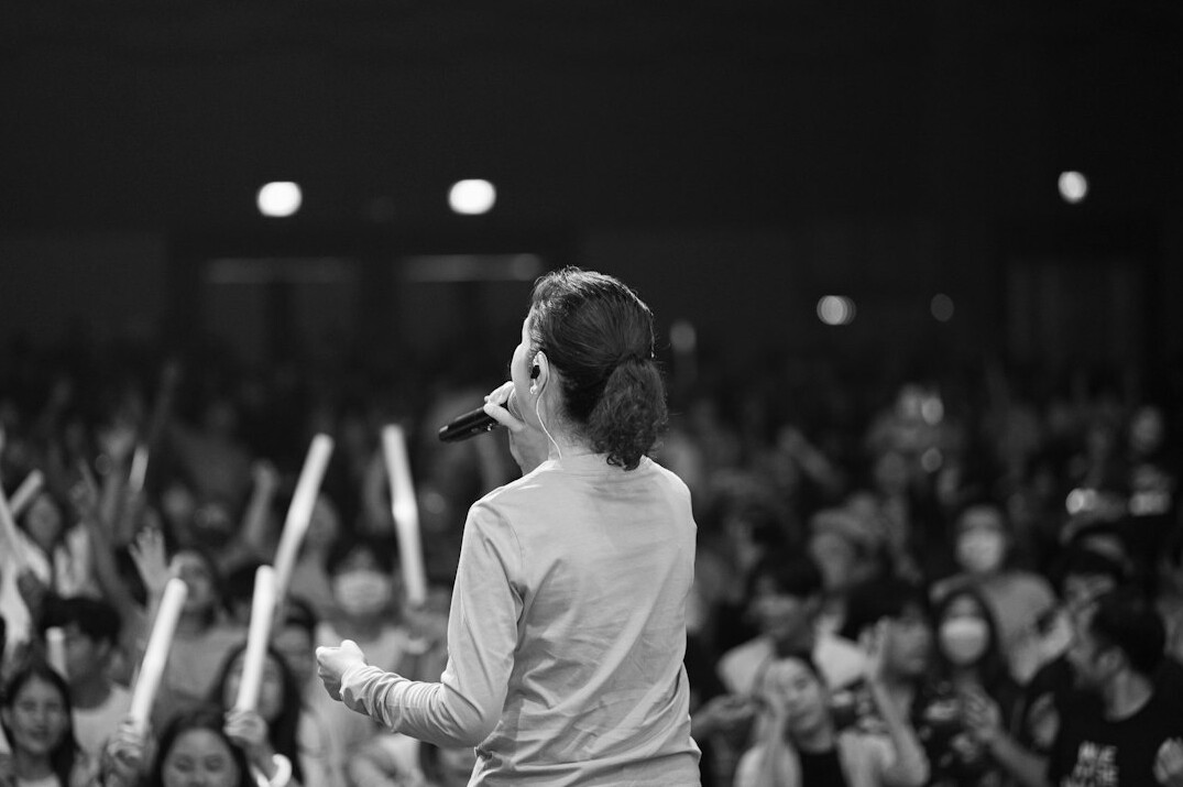 Person speaking confidently to a small audience