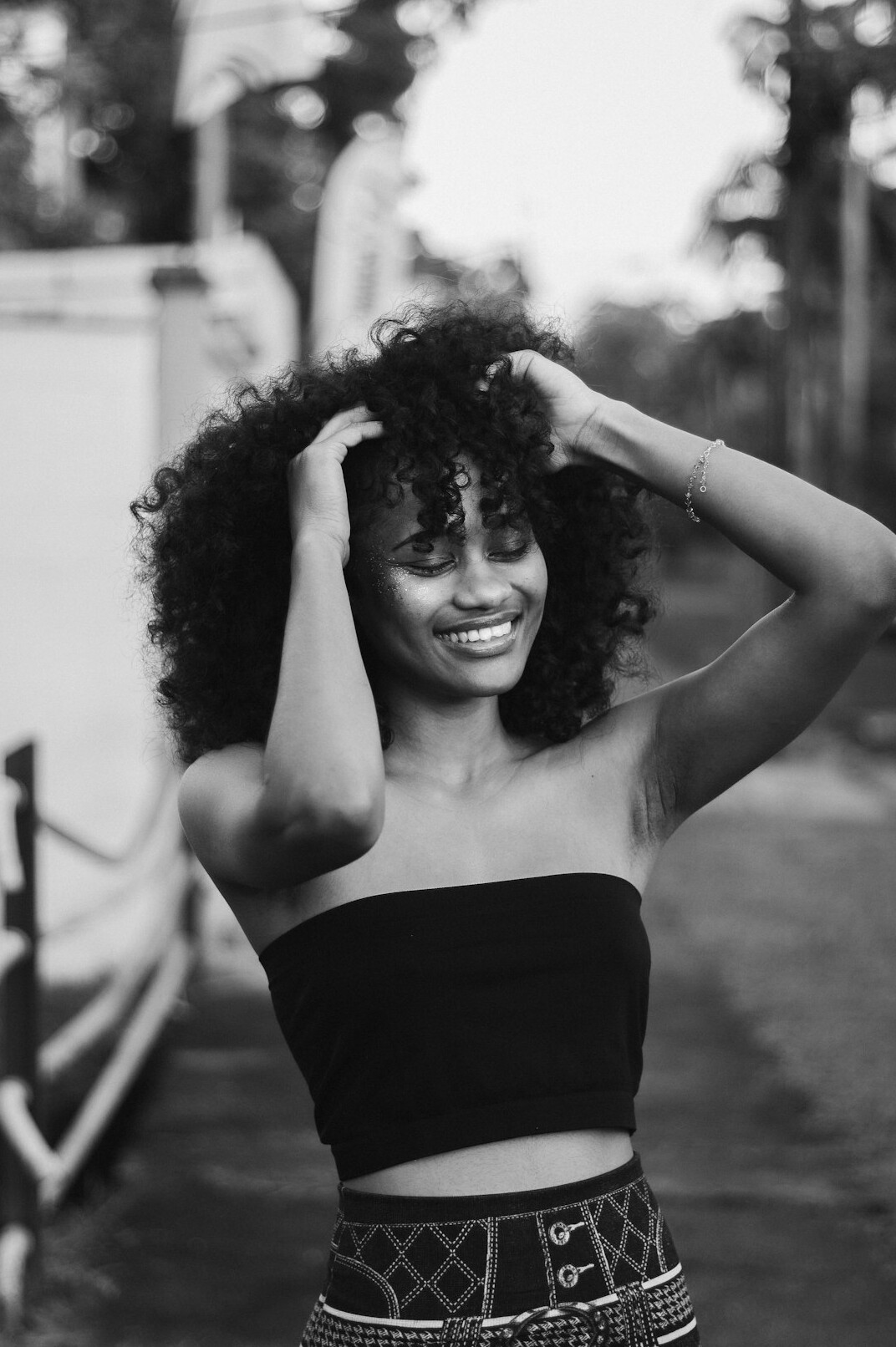 Studio portrait of a smiling Brazilian woman with curly hair